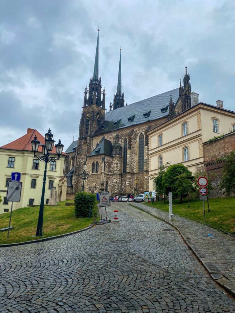 A picturesque cobblestone street in Brno, with the charming church of st. Peter and Paul in the background.