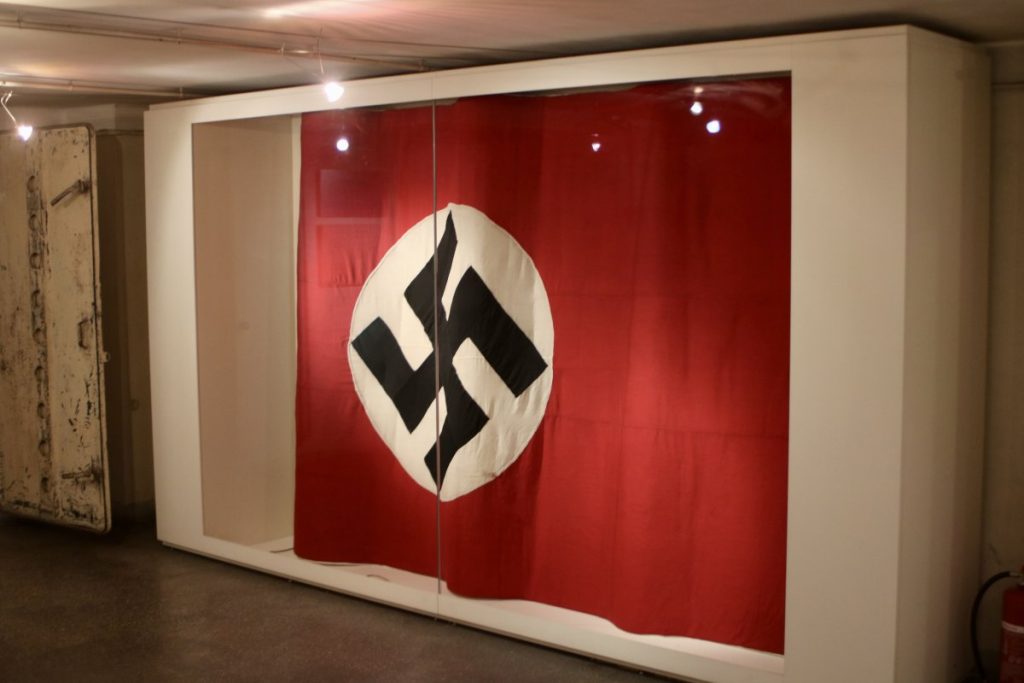 Athens dark tourism: The nazi flag that stands inside the memorial site. It was on the top of the building and is now exibited in the museum