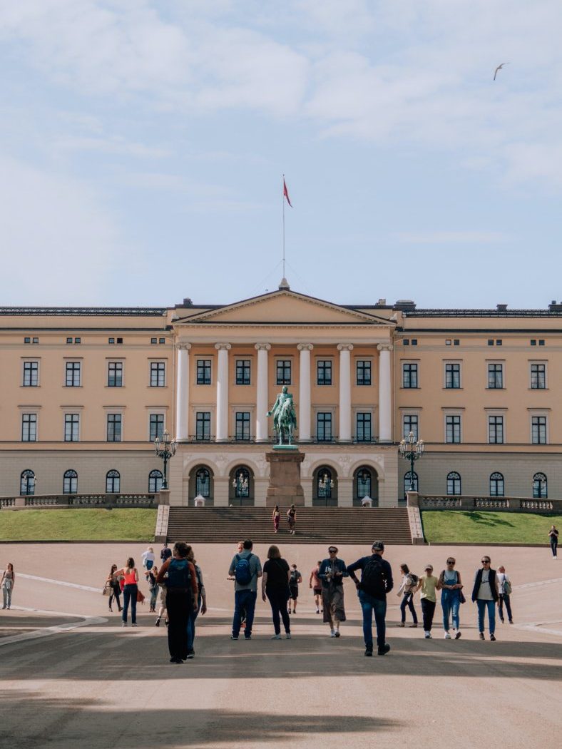  People walking around Oslo's Royal Palace