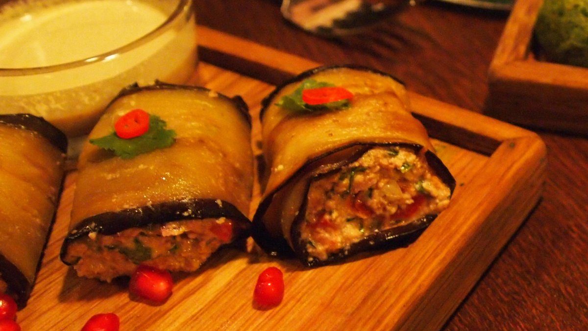 Badrijani Nigvzit, slices of eggplant rolled around a filling of spiced walnut paste.