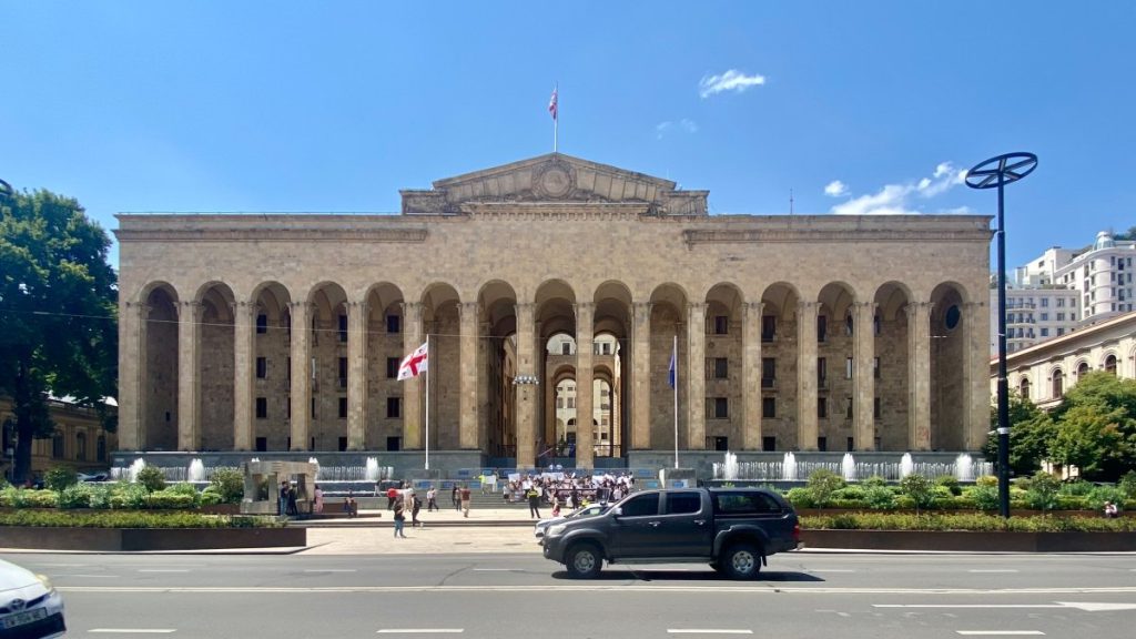The large parliament building with columns in front of it.