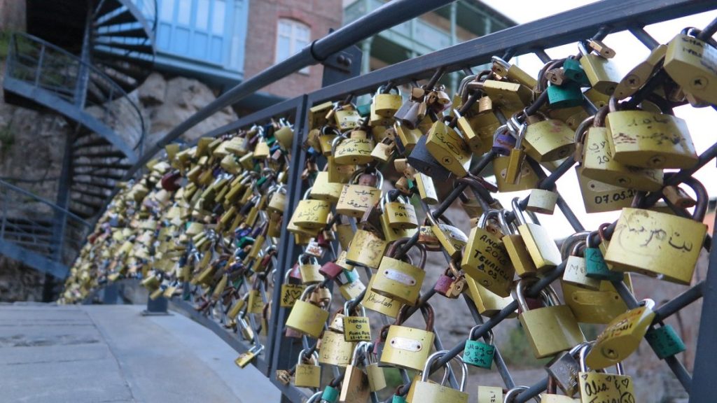 A bridge in Tbilisi adorned with numerous padlocks, making it a sight worth visiting.
