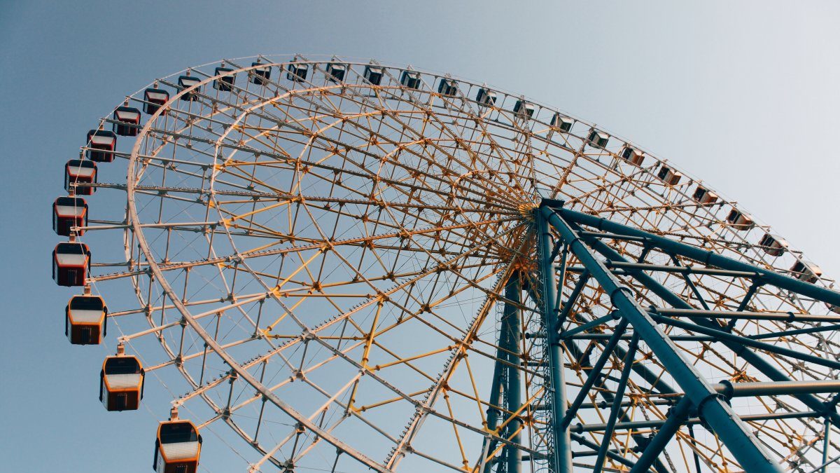 A ferris wheel against a blue sky.