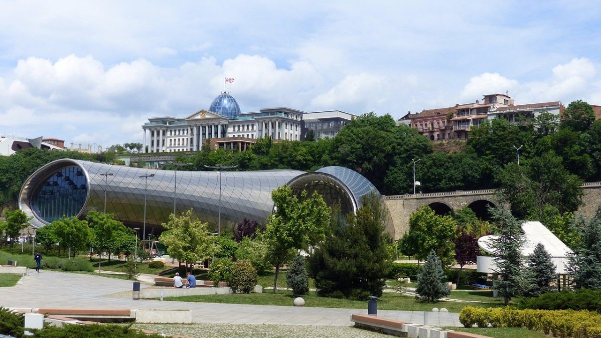 A large building in the middle of a park.