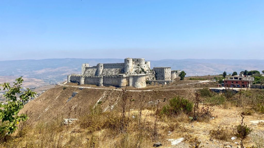 Krak des Chevaliers, one of the best preserved medieval castles in the world, as seen from a hill far away