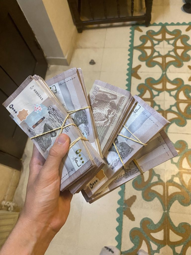 Holding 150 dollars in Syrian Lira. The country faces severe inflation