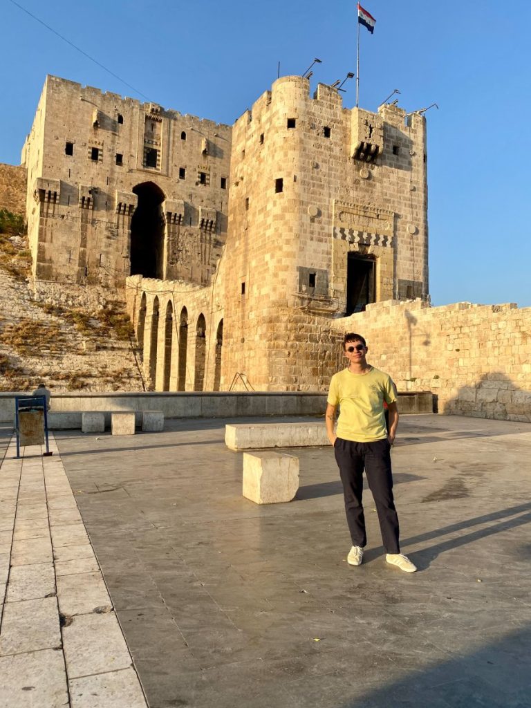 Me while traveling to Syria, standing in front of the Aleppo citadel