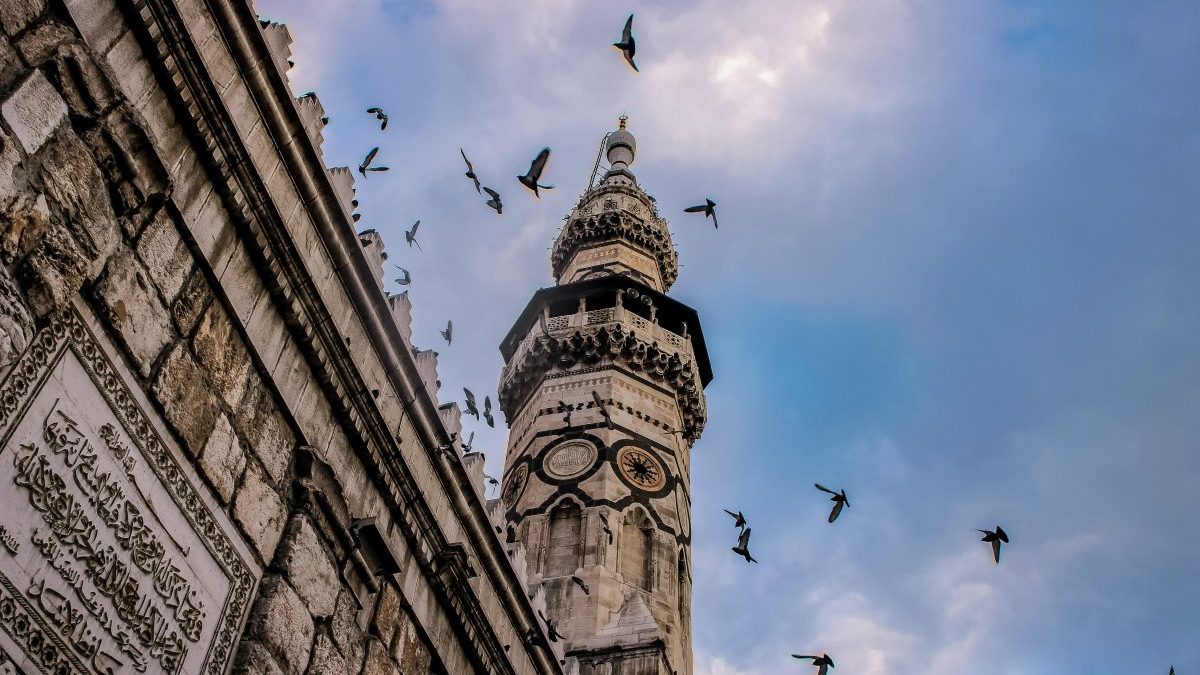 A minaret with birds flying around in the centre of Damascus, Syria
