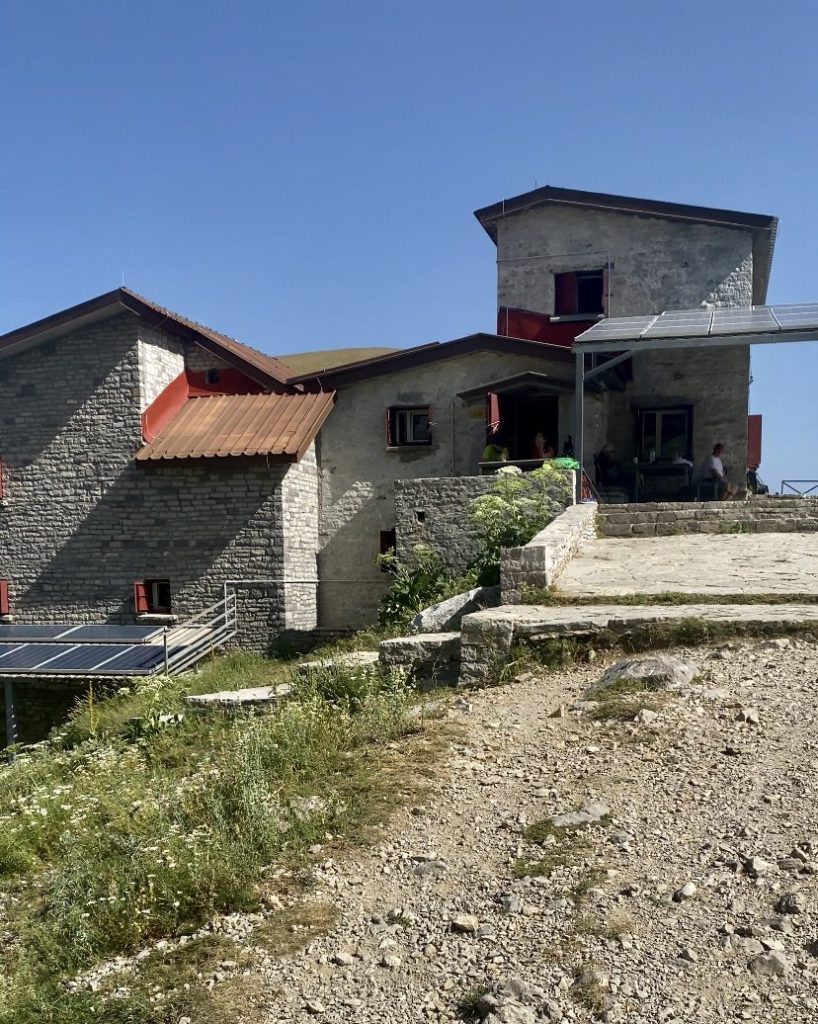 The Astraka refuge, a grey building used for travelers to rest