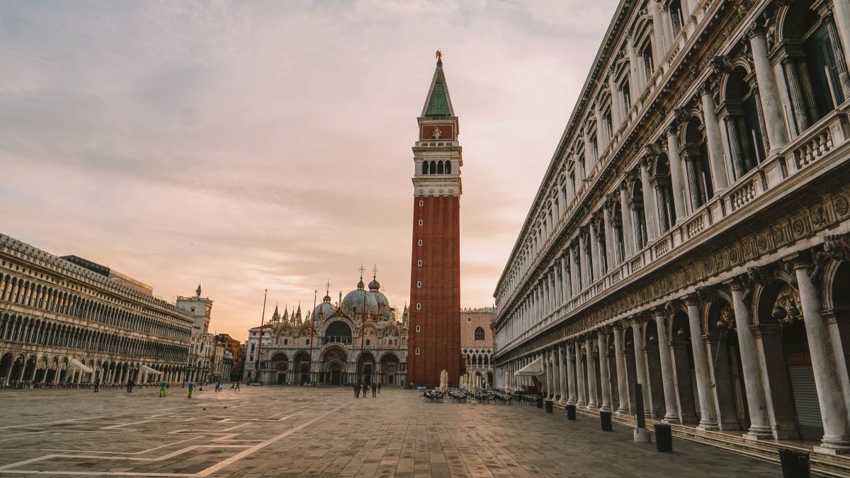 Piazza san Marco, Venice at sunset with the clock tower in the background.