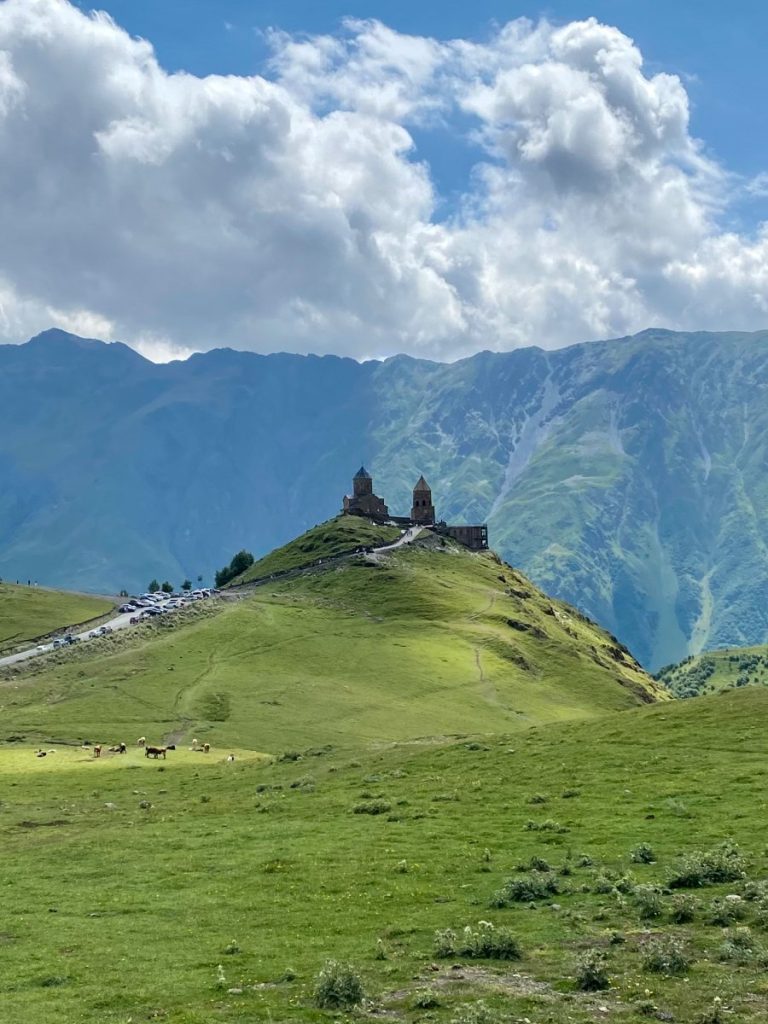 The Gergeti trinity Church, standing proudly in front of the chaotic russian mountains