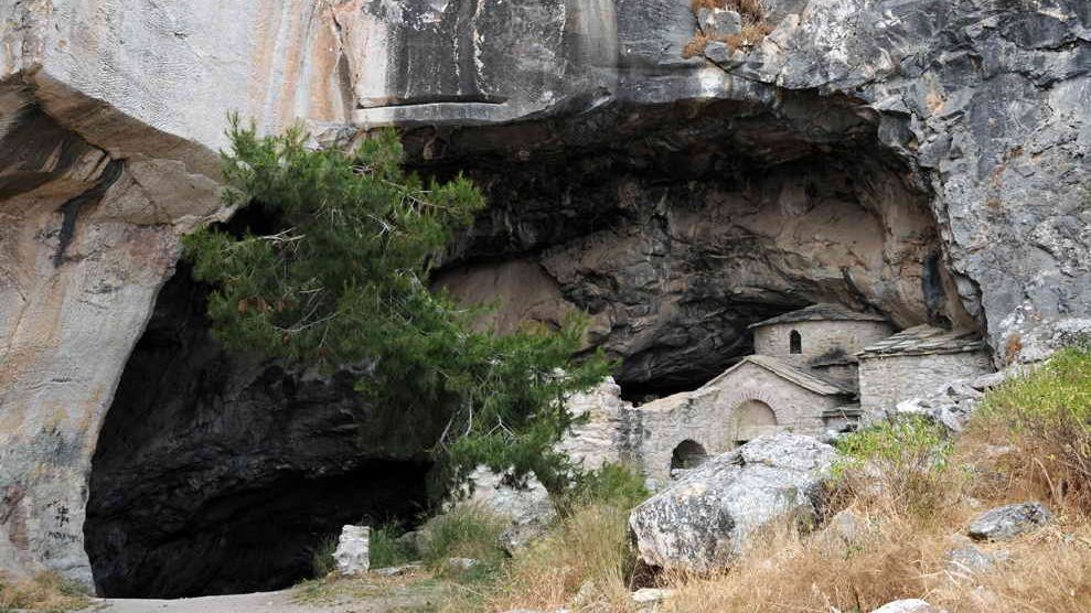 The Davelis cave entry with the church. was once thought to be the hideout of an infamous eighteenth-century outlaw, Davelis.