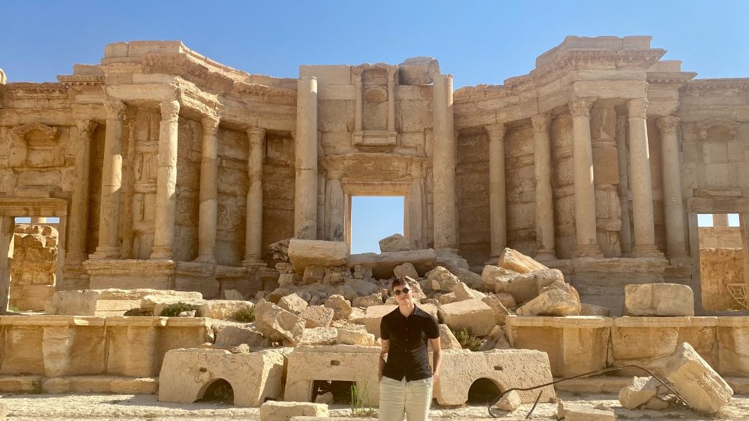 Me, standing amidst the destroyed amphitheater in Palmyra, Syria.