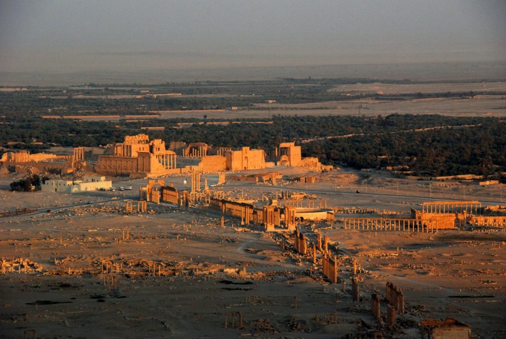 Explore the breathtaking ruins and captivating sculptures of the ancient city of Palmyra, Syria through an awe-inspiring aerial view.