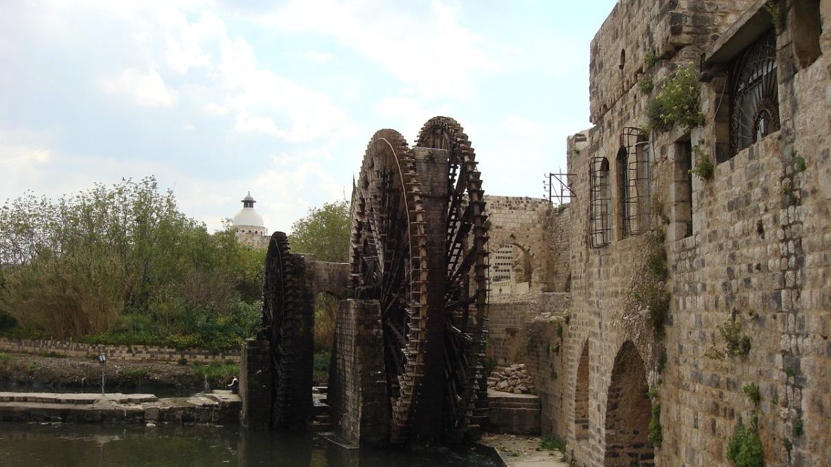 A water wheel in a stone building next to a river in Hama, Syria.