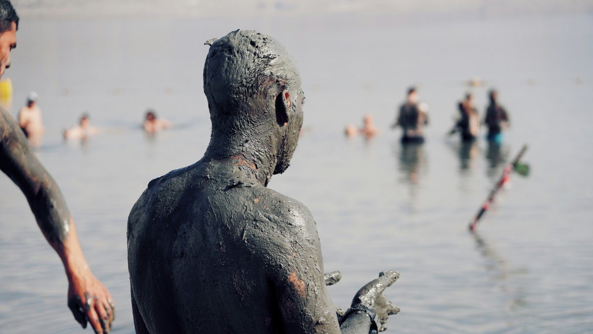 A person having a mad bath in Dead Sea, Jordan