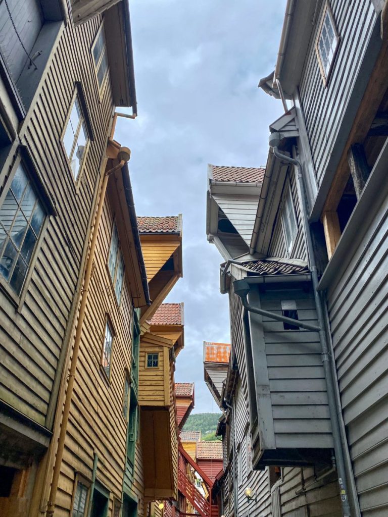The cozy wooden buildings of Bryggen from an alley inside