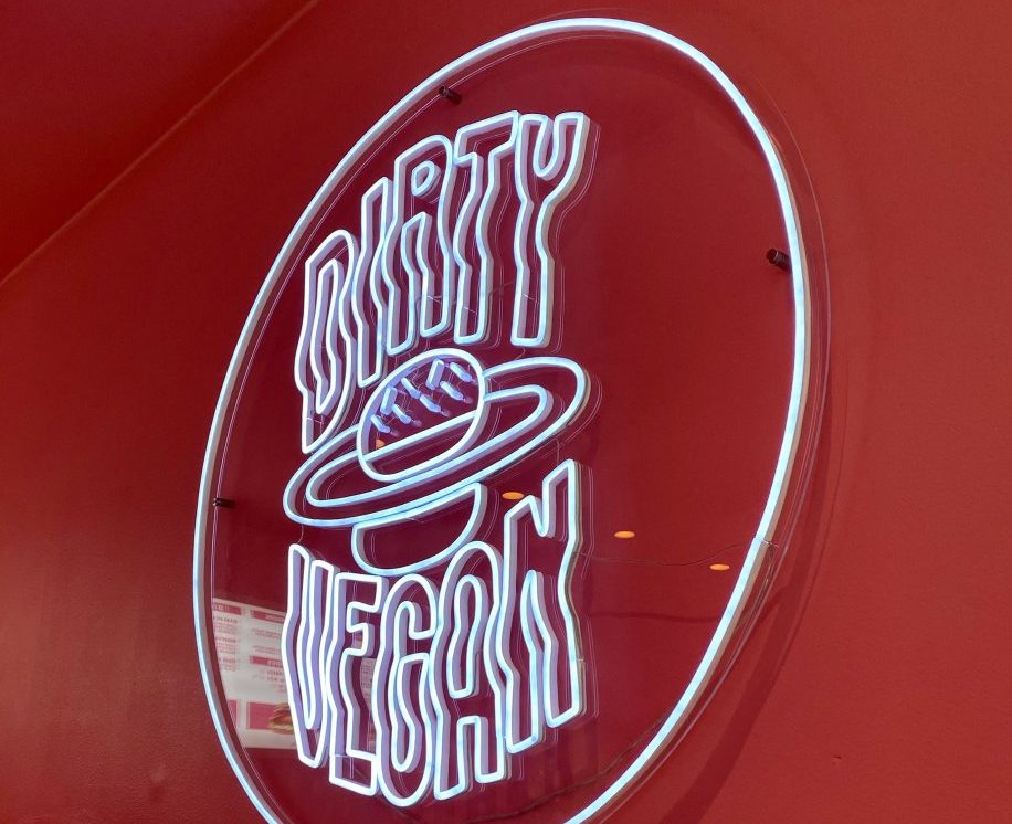 The logo of Dirty vegan in Bergen, in a neon sign that is located inside