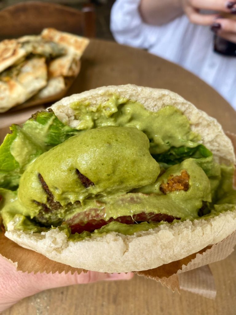 köfte Ekmek from Magic Kitchen of Exarcheia. It includes a soy patty, green salad, tomatoes, and their special green sauce