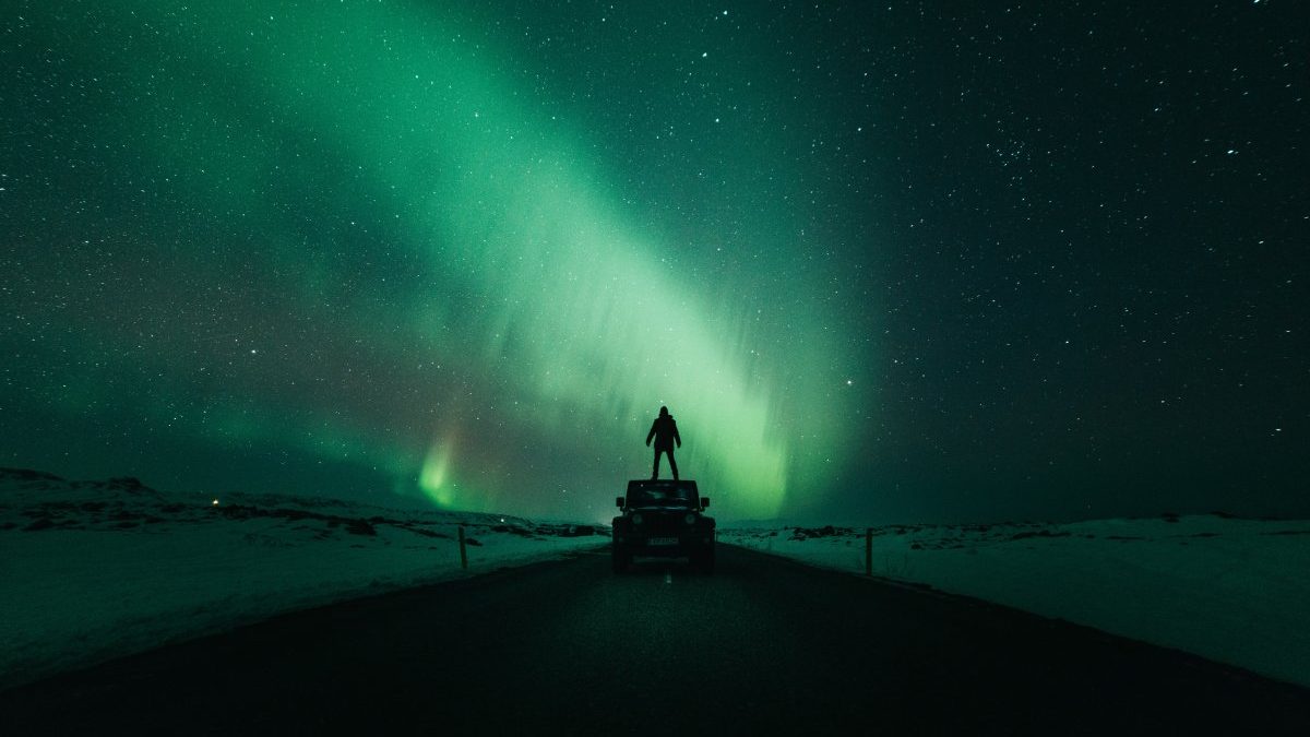 a car below the northern lights