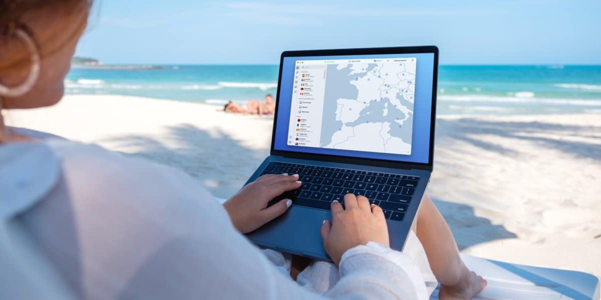 a woman in the Beach Using Nord VPN while traveling