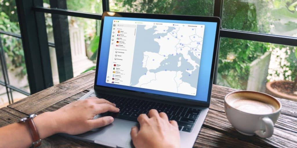 Someone drinking coffee while enjoying the best VPN for traveling abroad