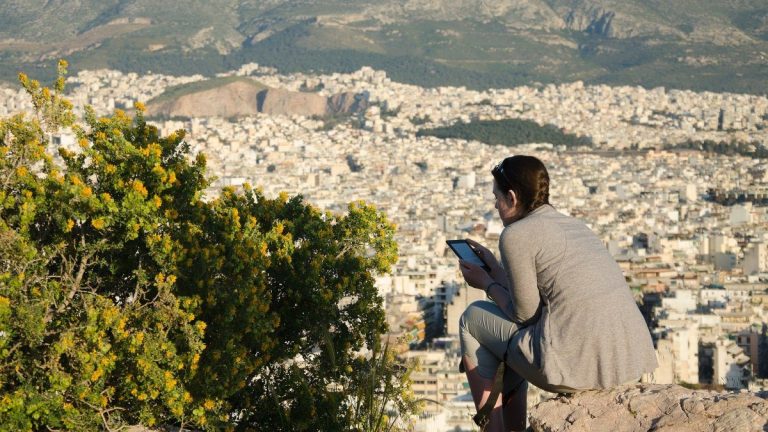 A woman sitting in a viewpoint in Athens