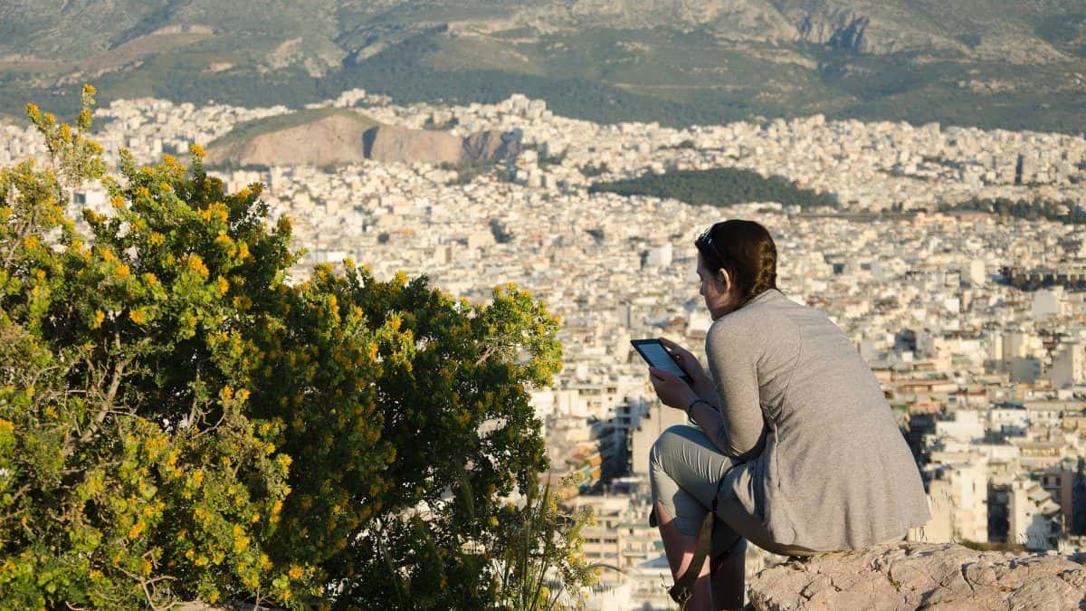 A woman sitting in a viewpoint in Athens