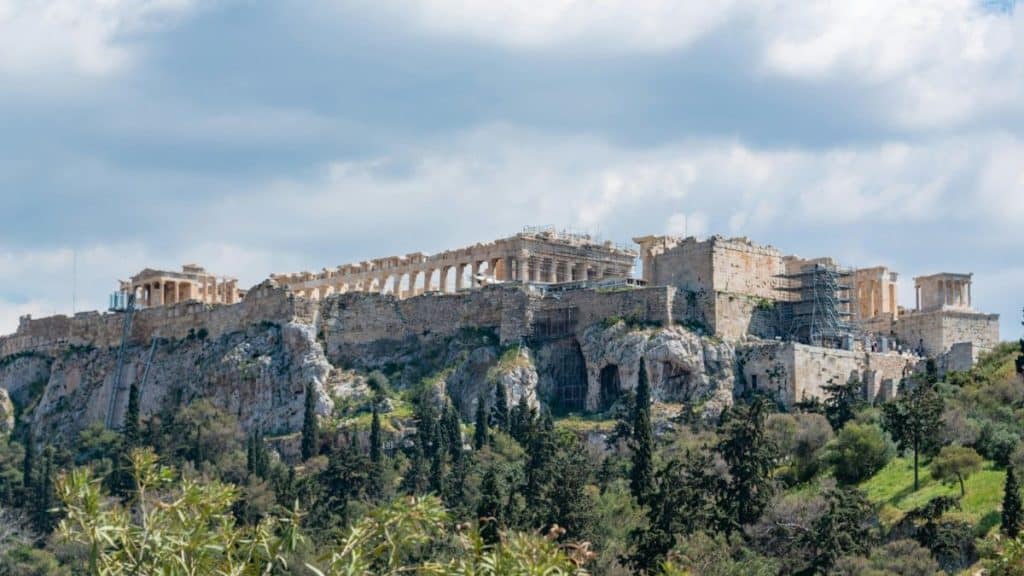 The image features the historic Parthenon temple on the Acropolis hill in Athens, Greece, highlighting ancient Greek architecture and cultural heritage.