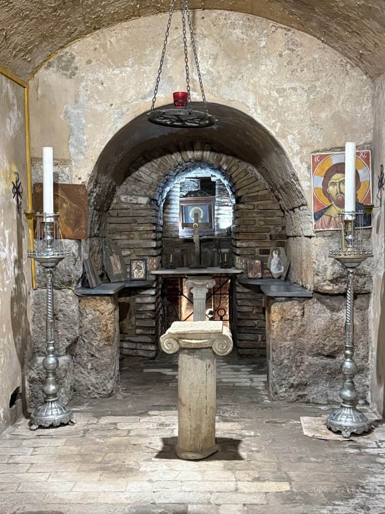An altar with orthodox icons and candles in a room in the catacombs under the holy trinity church. This is one of my favourite things to do in Athens.
